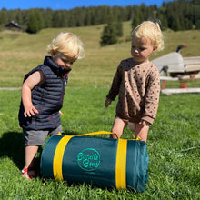 Load image into Gallery viewer, Two young toddlers outside by a bundled-up Toddler Bundle Bed Camping and Sleepover Bed, in Space Design. The best camping and sleepover toddler bed