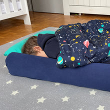 Load image into Gallery viewer, A small child asleep in his Bundle Bed at a sleepover, next to the bumper.