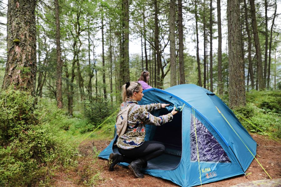 A Mum opening up a Vango Alpha 400 CLR 4 Person Family Tent 