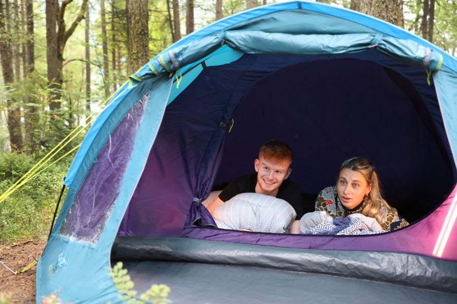 Two teenage children in a Vango Alpha 400 CLR 4 Person Tent 
