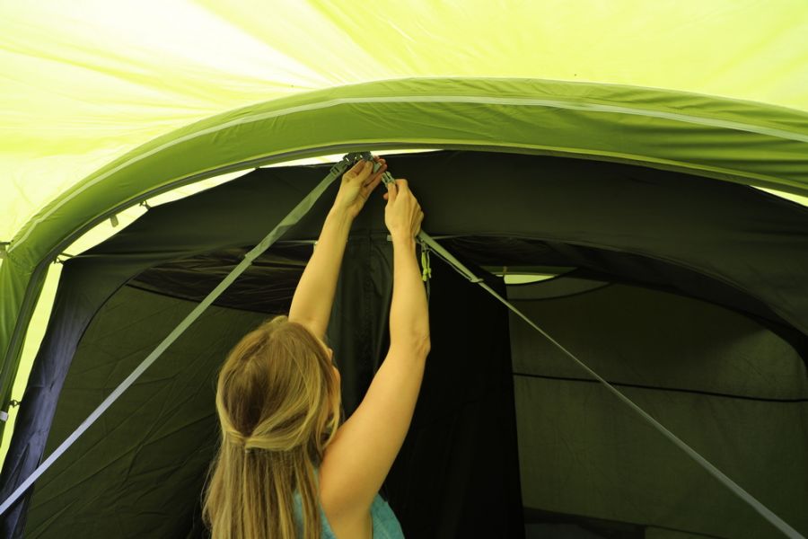 Mum fastening up a Vango Avington Flow Air 500 Best 5 Person Family Ait Tent at Kids Camping Store 