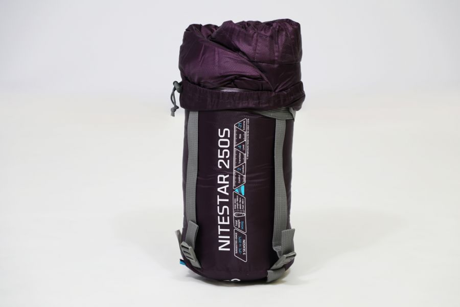 Vango Nitestar 250S (short) childrens sleeping bag in pheonix purple in bag stood on end