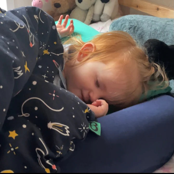 Young toddler girl asleep in a Toddler Bundle Bed Camping and Sleepover Bed, in Space Design. The best camping and sleepover toddler bed