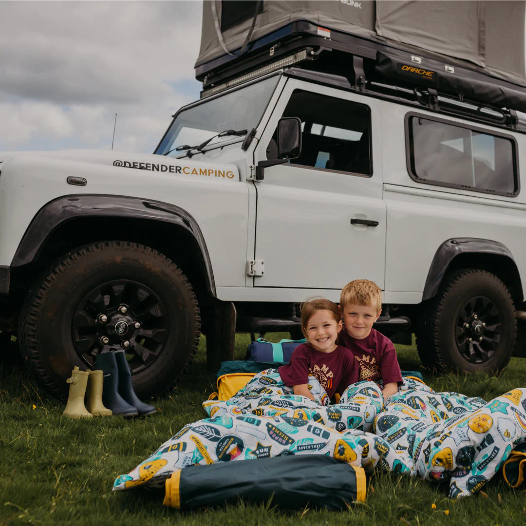 Two kids in a Motorhome in their Junior Bundle Bed Camping and Sleepover Bed