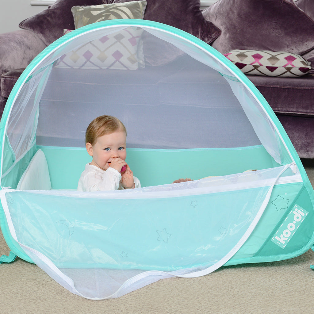 Baby in Pop-Up Travel Bubble Cot for camping babies, at Kids Camping Store
