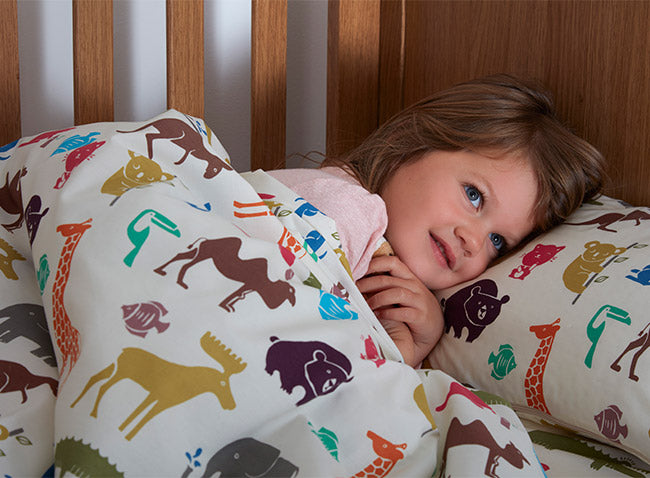 Girl in Dinky Duvalay, Childrens Luxury Camping Bed, at Kids Camping Store