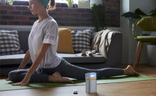Load image into Gallery viewer, Benq GV1 Portable Camping Projector whilst doing yoga
